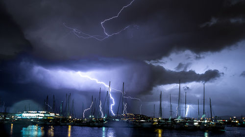 Lightning over harbor at night