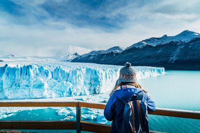 Rear view of woman looking at glacier from observation point