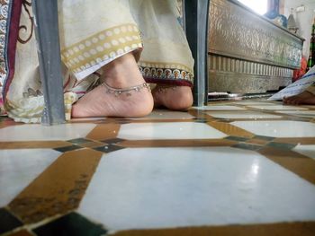 Low section of woman in sari on floor at temple