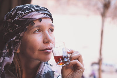 Thoughtful woman having tea