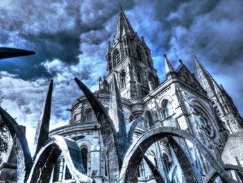 Low angle view of church against cloudy sky