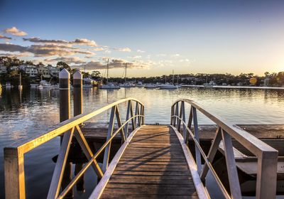 Pier on lake with boats in background