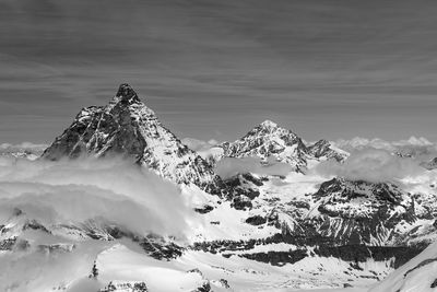 Scenic view of snow covered mountains against sky