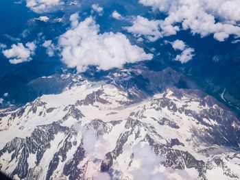 Scenic view of mountains against cloudy sky