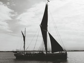 Sailboat sailing on sea against sky