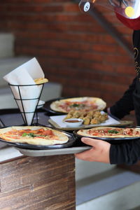 Midsection of person preparing food in restaurant