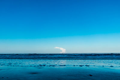 Scenic view of sea against clear blue sky