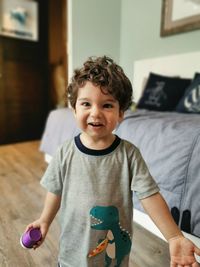 Portrait of cute baby boy standing at home