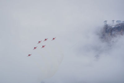 Low angle view of airshow against sky