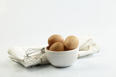 Close-up of eggs against white background