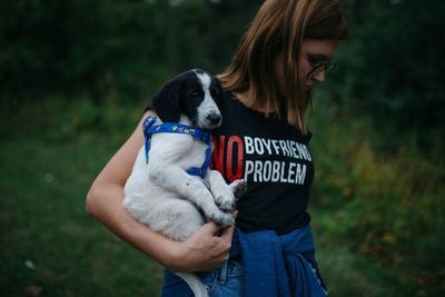 Woman with dog walking in forest