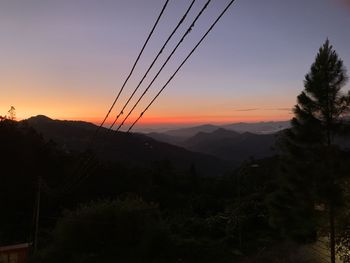 Scenic view of silhouette mountains against sky at sunset