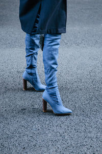 Low section of man walking on road