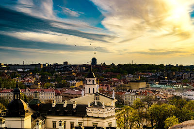 High angle view of vilnius cathedral and cityscape against cloudy sky during sunset