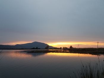 Scenic view of lake against sky during sunset