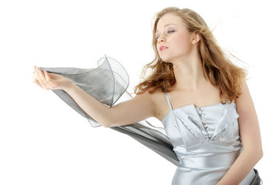 Young woman looking away against white background