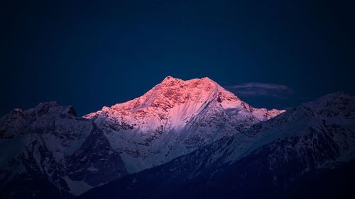 Scenic view of snowcapped mountains against clear sky