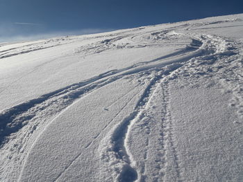 Snow covered landscape against sky