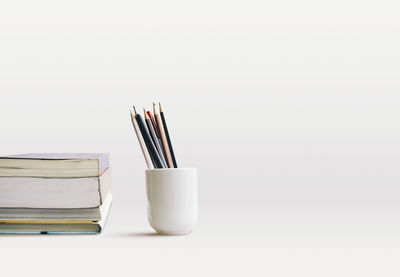 Close-up of books on table against white background