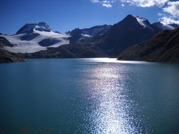 Scenic view of lake and mountains against sky