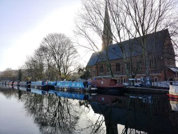 Boats in canal along buildings