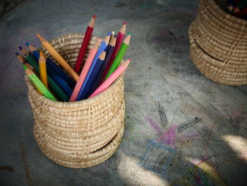 High angle view of colored pencils in basket