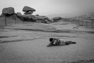 View of lying down on land against sky