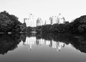 Reflection of buildings in lake against sky