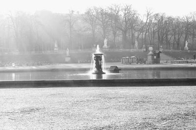 Statue by fountain in park
