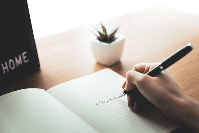 Hand holding book with text