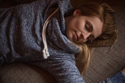 Directly above shot of woman lying on carpet