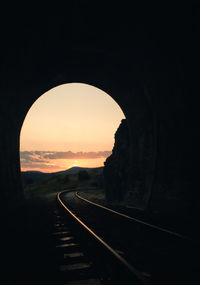 Dark tunnel against sky