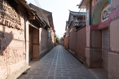 Narrow alley amidst buildings in city