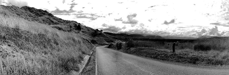 Empty road along countryside landscape