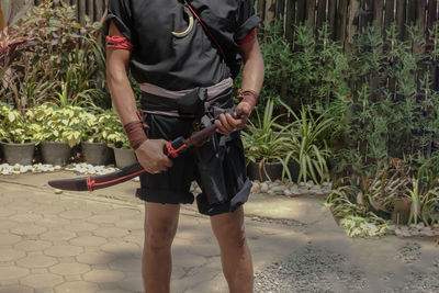 Full length of man standing against plants