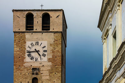 Low angle view of clock tower against sky