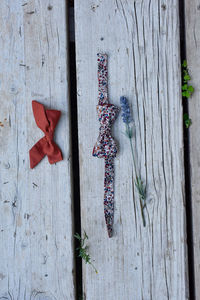 Close-up of dead plant hanging on wooden fence