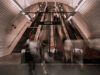 Blurred motion of people walking in subway station