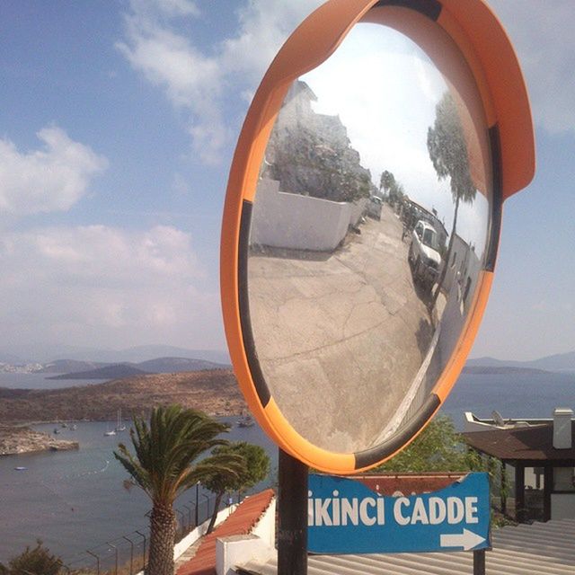 sky, circle, text, communication, cloud - sky, cloud, transportation, western script, close-up, day, outdoors, no people, sign, beach, road sign, mountain, nature, sea, geometric shape, mode of transport