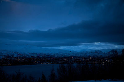 Scenic view of lake against sky at night