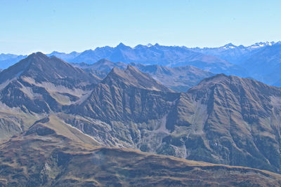 Scenic view of mountains against blue sky