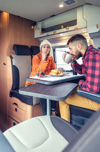 People sitting on seat in room