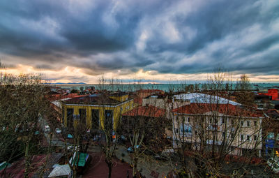 View of cityscape against cloudy sky