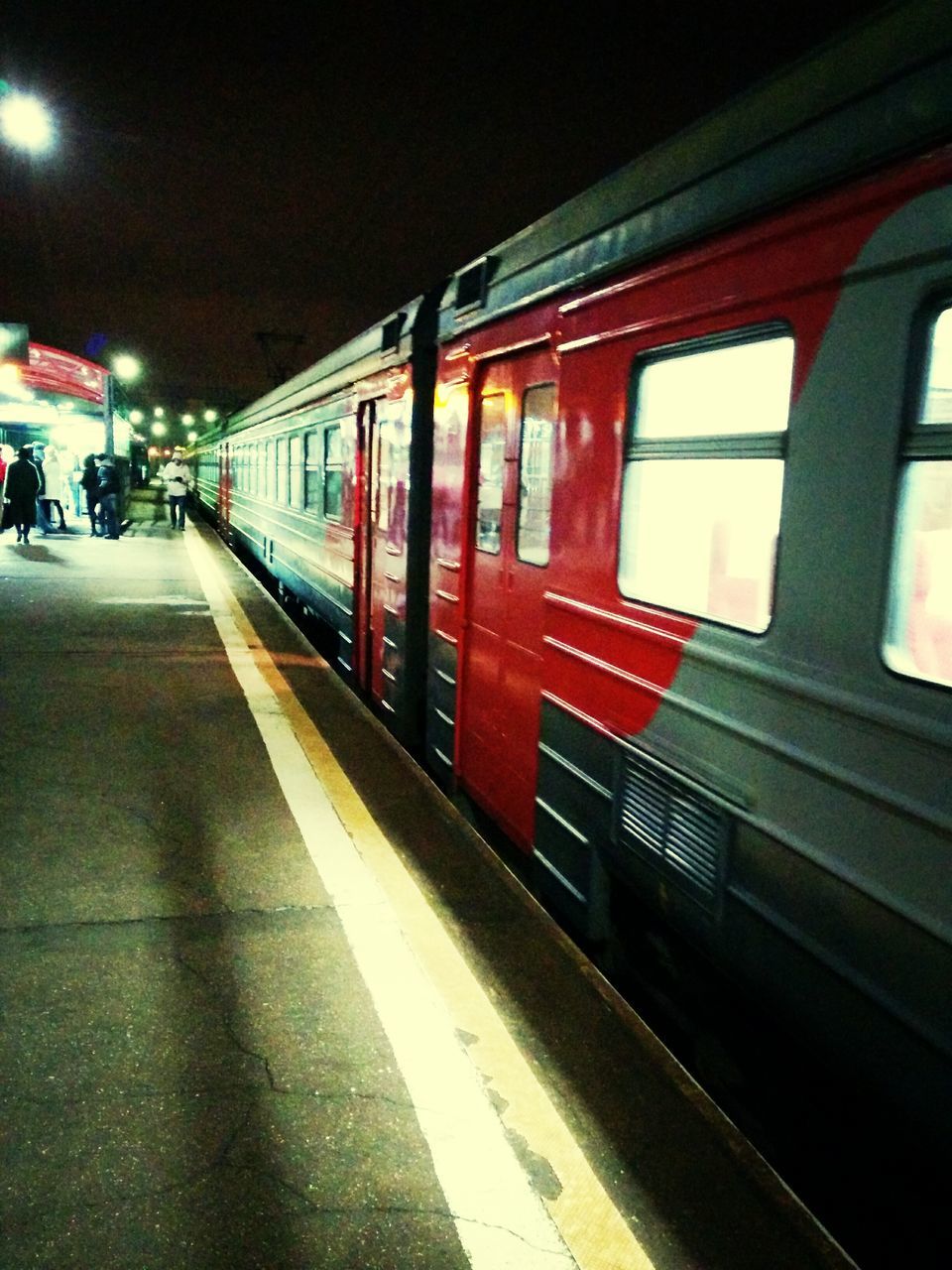 transportation, railroad station platform, public transportation, railroad station, illuminated, mode of transport, railroad track, rail transportation, train - vehicle, travel, night, architecture, built structure, passenger train, land vehicle, incidental people, indoors, public transport, on the move, train