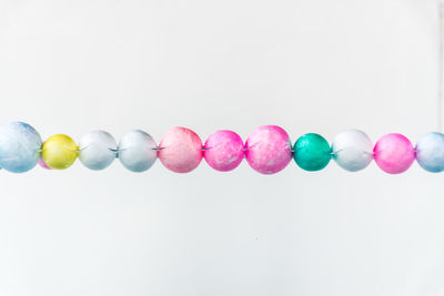 Close-up of multi colored candies against white background