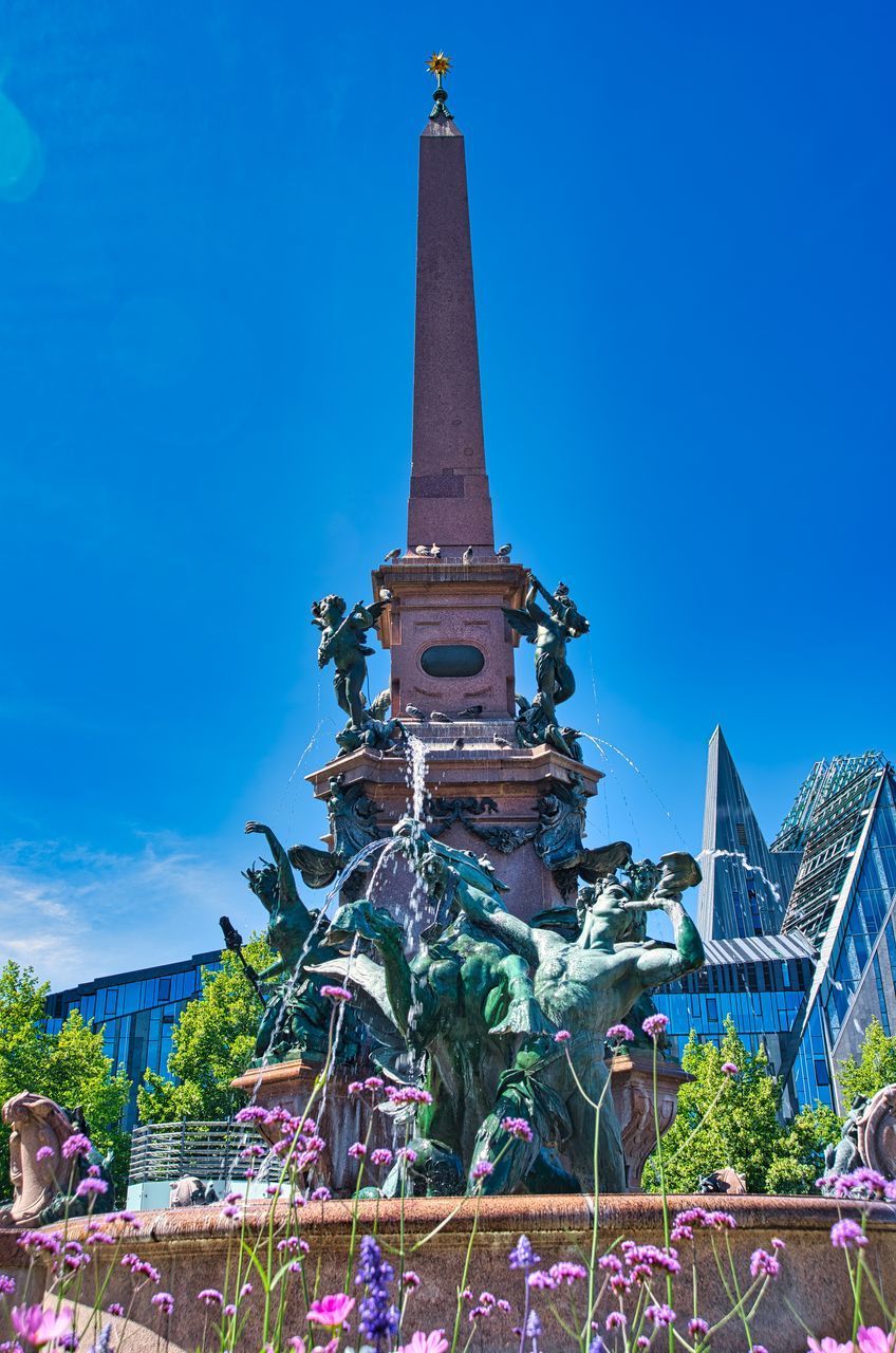 LOW ANGLE VIEW OF BUILDING AGAINST BLUE SKY