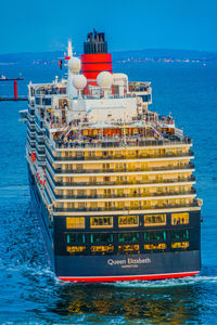 Ship sailing on sea against blue sky