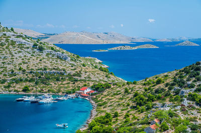 High angle view of townscape by sea against sky
