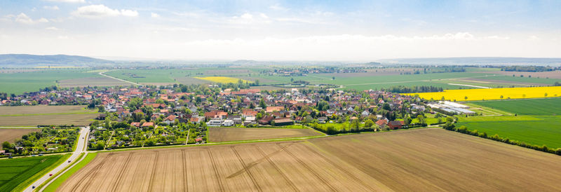 Panoramic view of agricultural field against sky