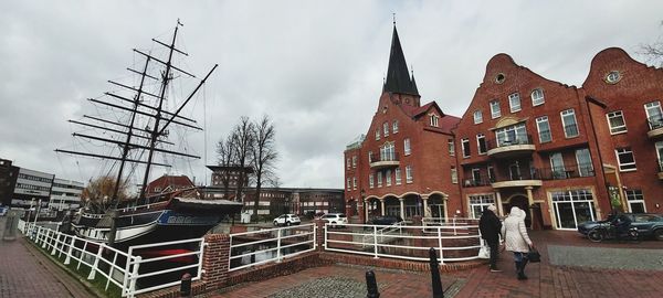 Panoramic view of buildings in city against sky